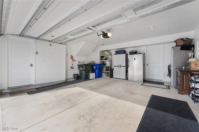 4006 N Steels Cir, Stow, OH 44224 - garage featuring freestanding refrigerator and a garage door opener
