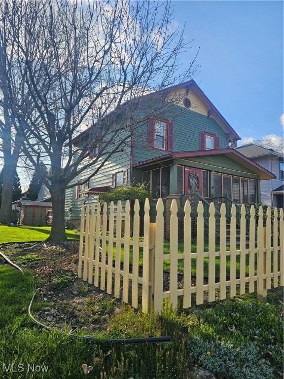445 N 18th St, Sebring, OH 44672 - view of side of home with a sunroom and fence