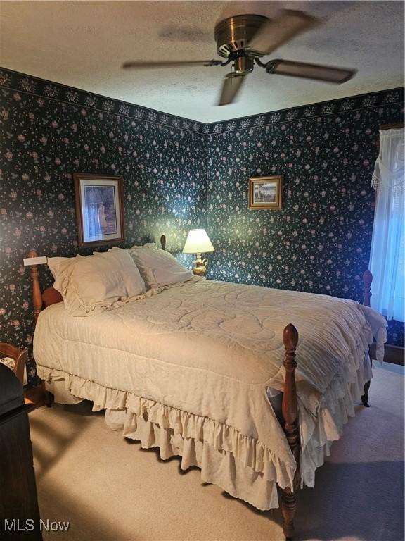 445 N 18th St, Sebring, OH 44672 - bedroom with wallpapered walls, carpet floors, a textured ceiling, and ceiling fan