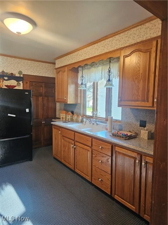 445 N 18th St, Sebring, OH 44672 - kitchen with light countertops, freestanding refrigerator, ornamental molding, and a sink