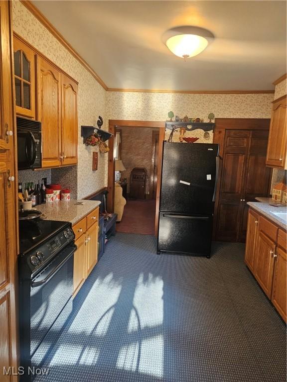 445 N 18th St, Sebring, OH 44672 - kitchen featuring crown molding, wallpapered walls, black appliances, brown cabinets, and light countertops