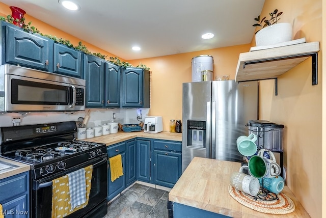 1865 9th St SW, Akron, OH 44314 - kitchen featuring blue cabinets, butcher block counters, and appliances with stainless steel finishes
