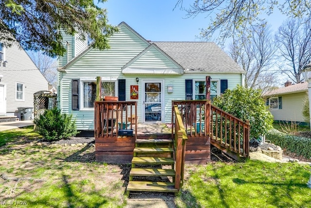 1865 9th St SW, Akron, OH 44314 - view of front of house featuring a shingled roof, a chimney, and a deck