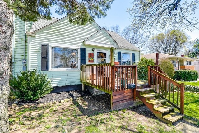 1865 9th St SW, Akron, OH 44314 - rear view of house featuring roof with shingles and a deck