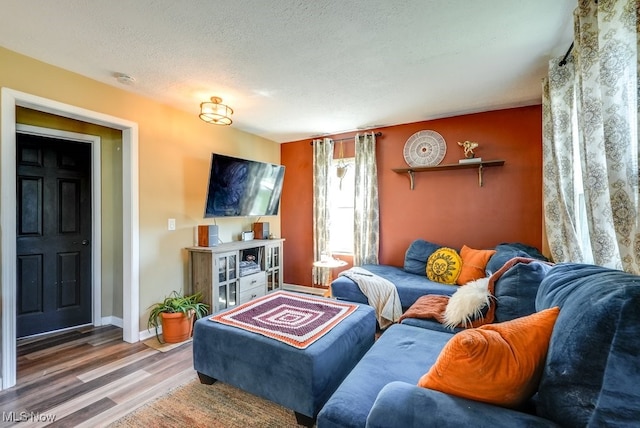 1865 9th St SW, Akron, OH 44314 - living area with baseboards, wood finished floors, and a textured ceiling