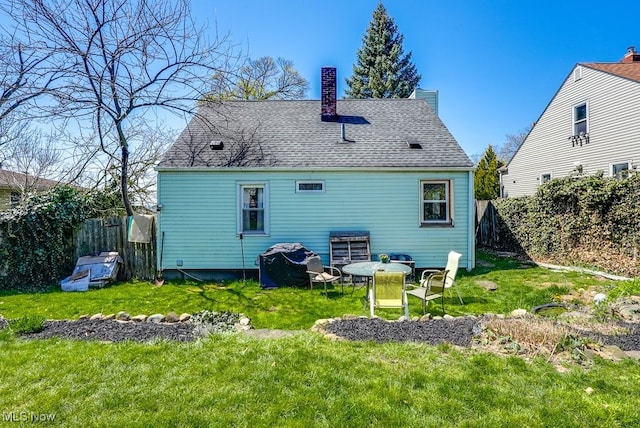 1865 9th St SW, Akron, OH 44314 - back of property with a lawn, a chimney, and fence