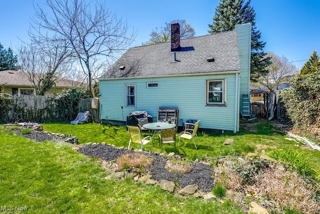 1865 9th St SW, Akron, OH 44314 - rear view of house with a chimney, roof with shingles, fence, and a yard