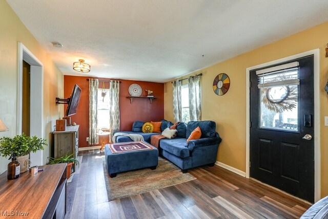 1865 9th St SW, Akron, OH 44314 - living area featuring baseboards and dark wood-style flooring