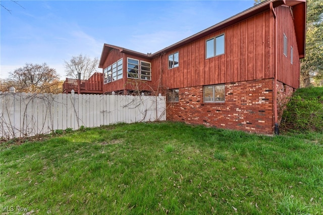 view of side of property with a yard