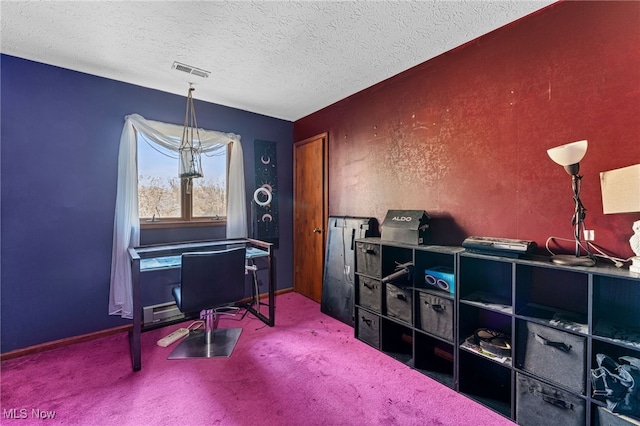 home office with a textured ceiling, carpet, and visible vents