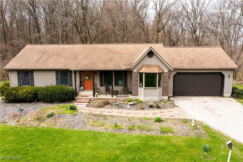 8017 Joppa Rd, Huron, OH 44839 - single story home with a garage, dirt driveway, a front lawn, and covered porch