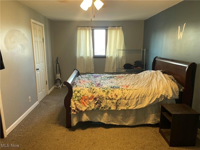 carpeted bedroom with ceiling fan and baseboards