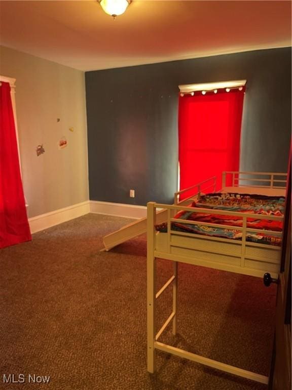 bedroom featuring baseboards and carpet flooring