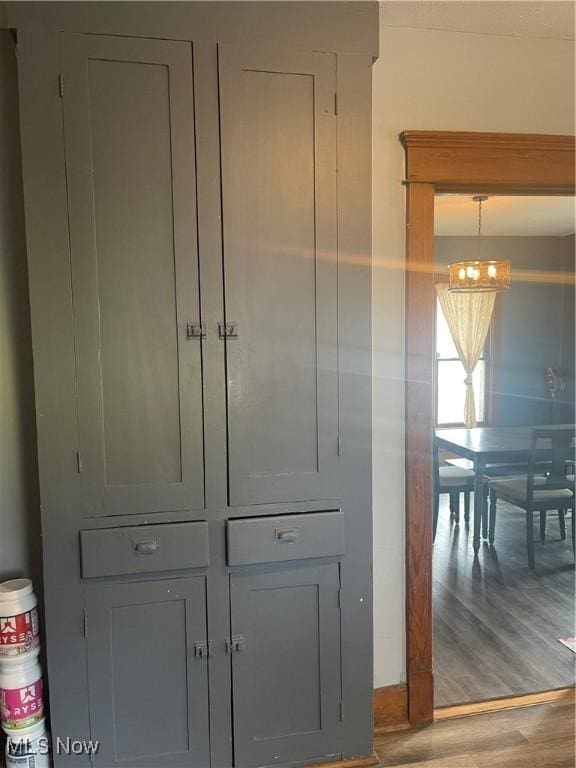interior details featuring a chandelier and wood finished floors