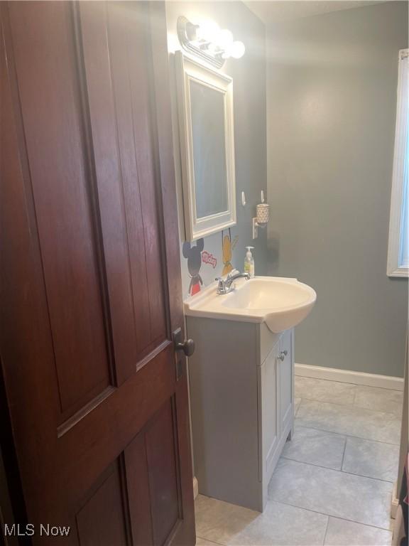 bathroom featuring baseboards and vanity
