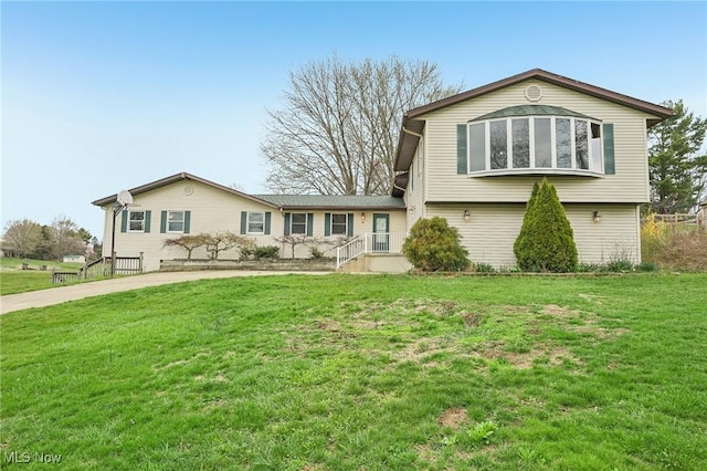 tri-level home with a front lawn