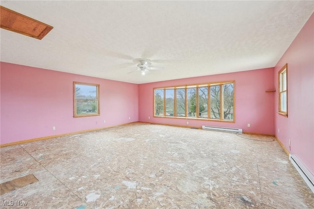 spare room with a baseboard radiator, baseboards, a ceiling fan, and a textured ceiling