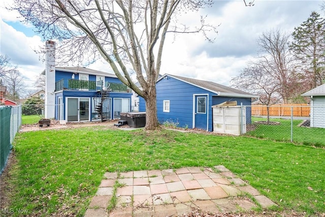 366 Portage St, Wadsworth, OH 44281 - back of house featuring a fenced backyard, a hot tub, a chimney, and a lawn