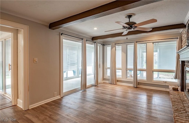 366 Portage St, Wadsworth, OH 44281 - unfurnished room featuring a ceiling fan, wood-type flooring, beam ceiling, crown molding, and a glass covered fireplace