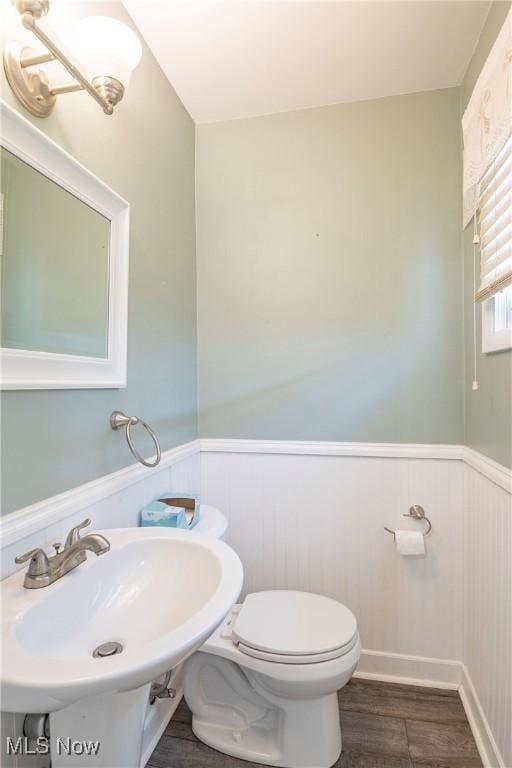 366 Portage St, Wadsworth, OH 44281 - bathroom with wainscoting, toilet, wood finished floors, and a sink