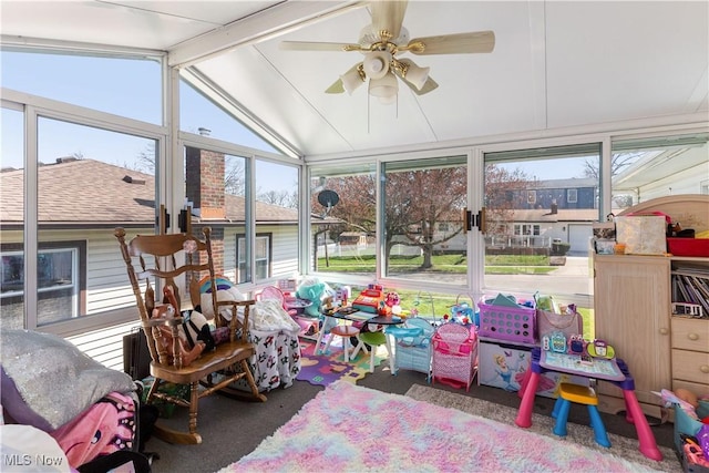 sunroom / solarium with lofted ceiling and a healthy amount of sunlight