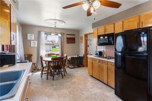 kitchen with light countertops, backsplash, a ceiling fan, a sink, and black appliances