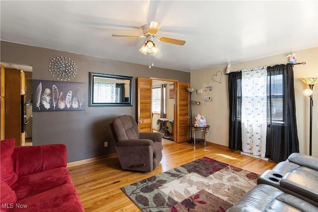 living room featuring ceiling fan and light wood-style floors