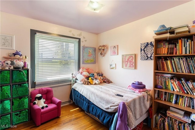 bedroom featuring baseboards and wood finished floors