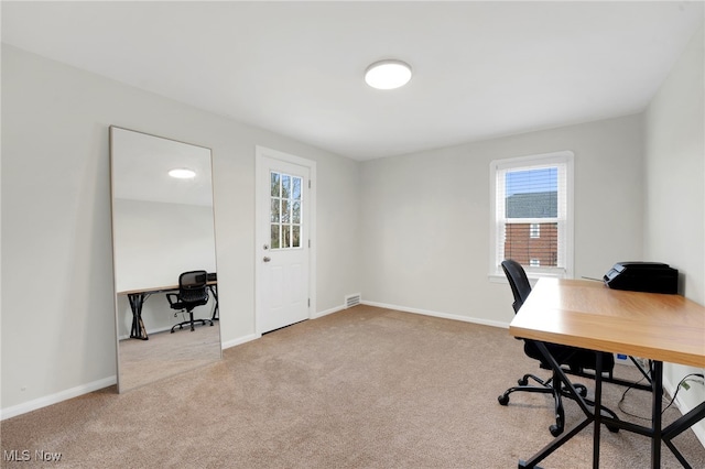 carpeted home office with baseboards