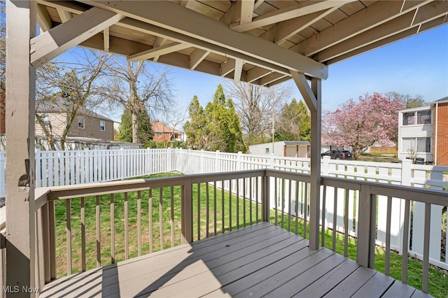 wooden terrace with a yard, a residential view, and fence private yard
