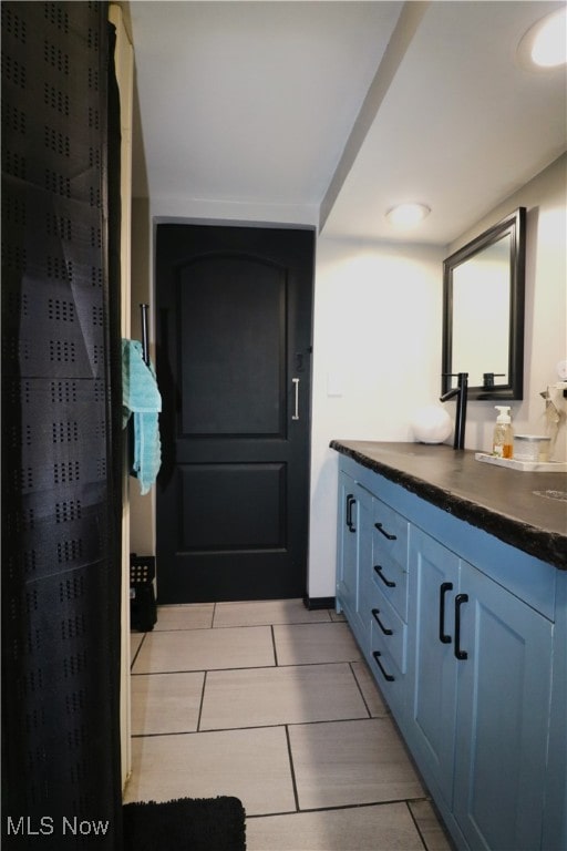 bathroom with tile patterned floors and vanity