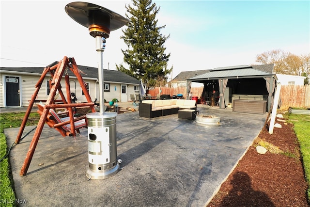 view of patio with a gazebo, an outdoor hangout area, and fence