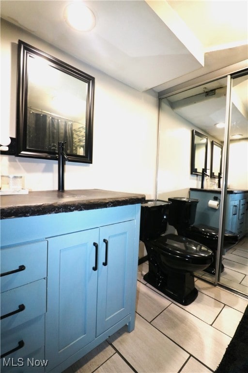 bathroom with toilet and vanity