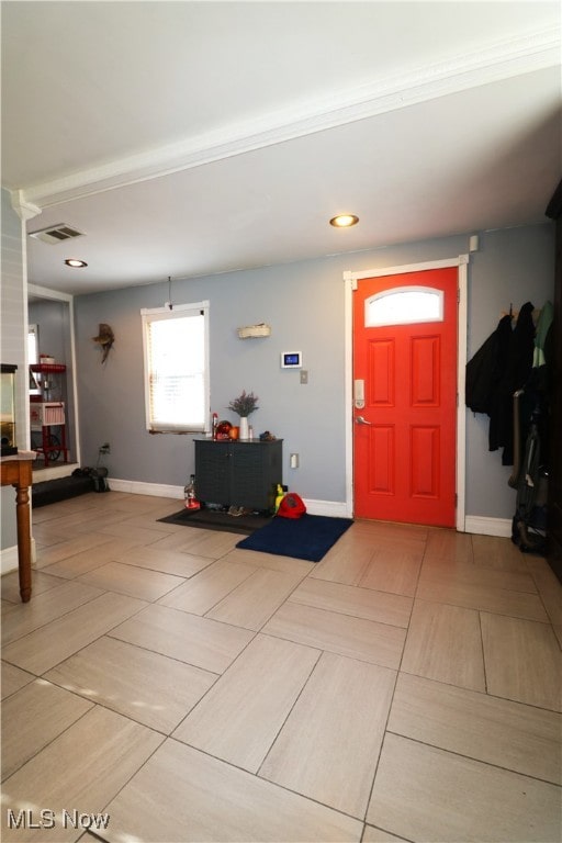 foyer entrance with baseboards, visible vents, and light tile patterned floors