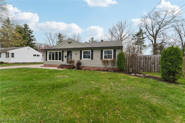 view of front of property with a front lawn and fence
