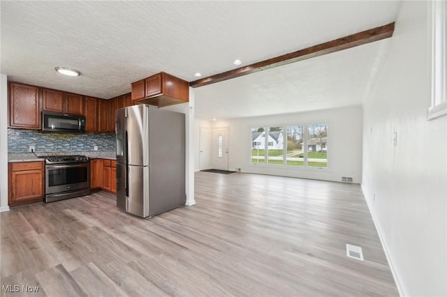 kitchen with light wood-type flooring, open floor plan, visible vents, and appliances with stainless steel finishes
