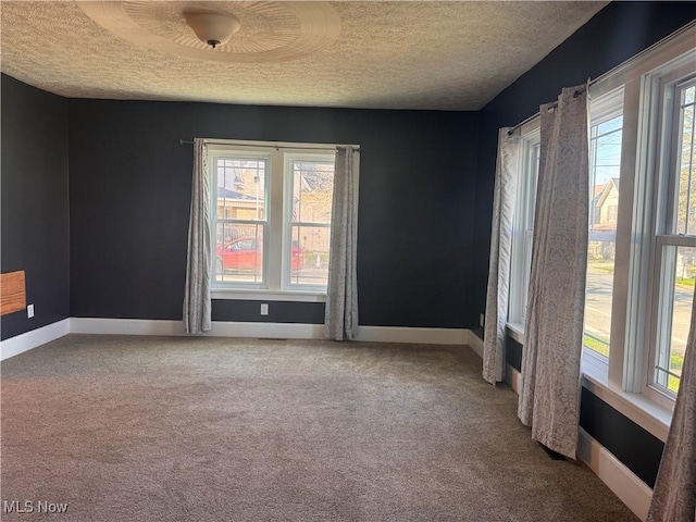 204 N Spring St, Loudonville, OH 44842 - carpeted empty room featuring a textured ceiling and baseboards
