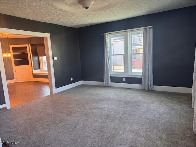 204 N Spring St, Loudonville, OH 44842 - carpeted spare room featuring a textured ceiling and baseboards