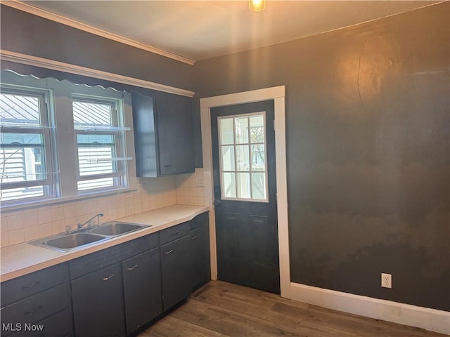 204 N Spring St, Loudonville, OH 44842 - kitchen with a sink, decorative backsplash, dark wood finished floors, and light countertops