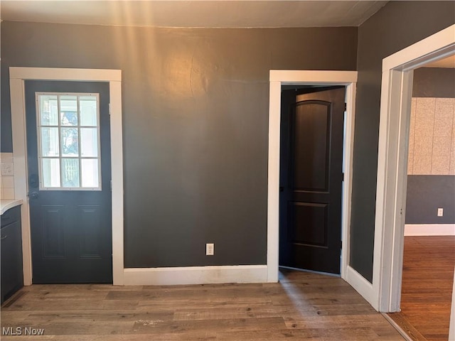 204 N Spring St, Loudonville, OH 44842 - doorway with wood finished floors and baseboards