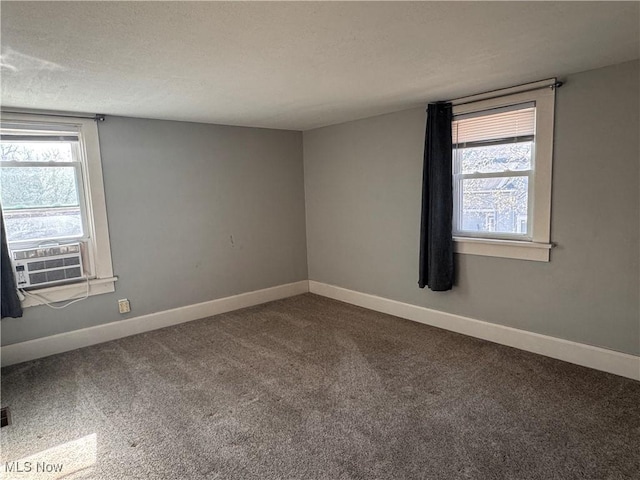 204 N Spring St, Loudonville, OH 44842 - carpeted spare room featuring cooling unit, baseboards, and a textured ceiling