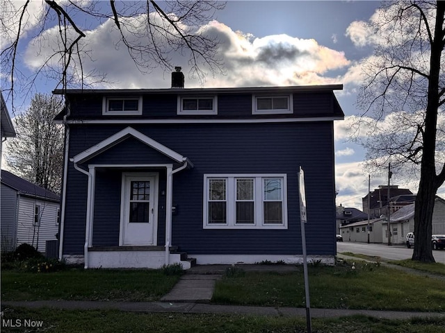 204 N Spring St, Loudonville, OH 44842 - view of front of house featuring a chimney and a front yard