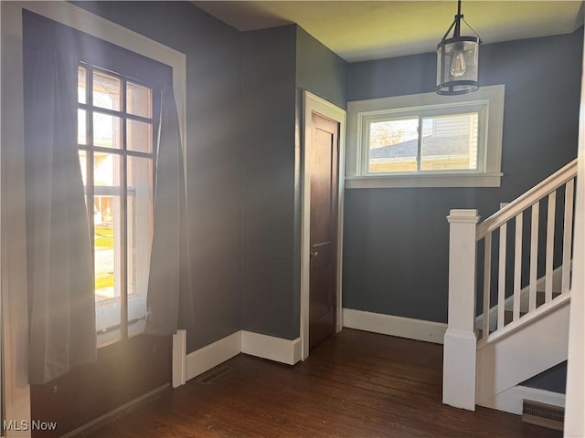 204 N Spring St, Loudonville, OH 44842 - entrance foyer with plenty of natural light, dark wood-type flooring, stairs, and baseboards