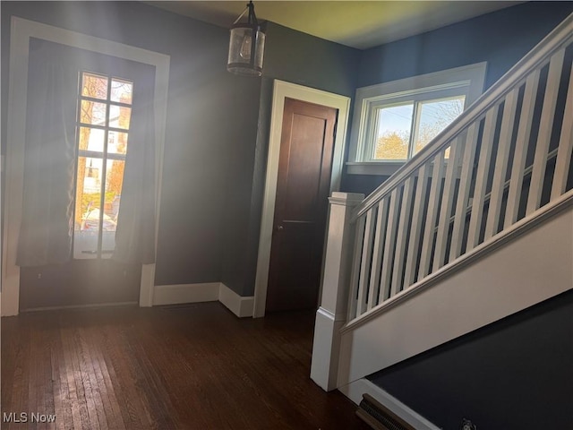 204 N Spring St, Loudonville, OH 44842 - foyer featuring dark wood-style floors, baseboards, stairs, and a chandelier