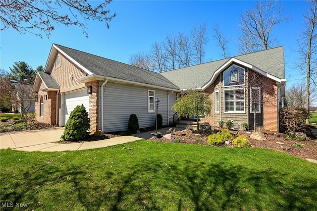ranch-style home with brick siding, an attached garage, and a front lawn