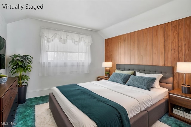 carpeted bedroom featuring vaulted ceiling