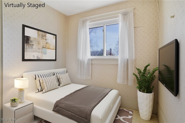 bedroom with wallpapered walls