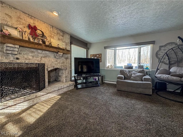 living area with a baseboard heating unit, carpet floors, a fireplace, and a textured ceiling