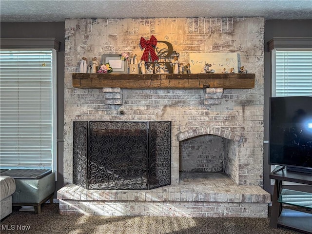 interior details with a brick fireplace and a textured ceiling