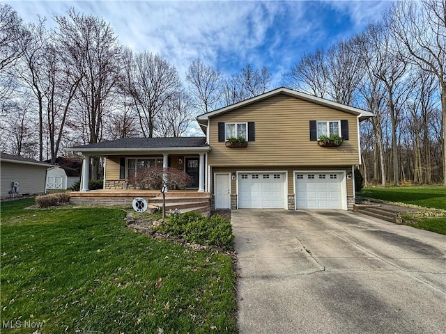 tri-level home featuring a garage, driveway, a porch, and a front yard